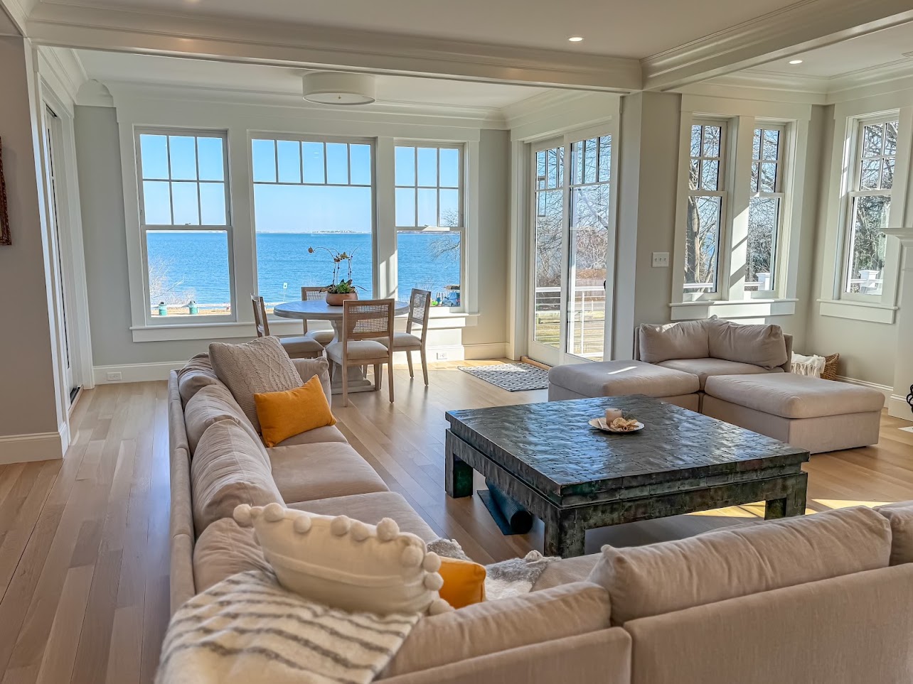 Open living and dining spaces with wide windows overlooking the ocean